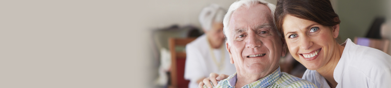 Adult daughter smiling next to her smiling elderly father